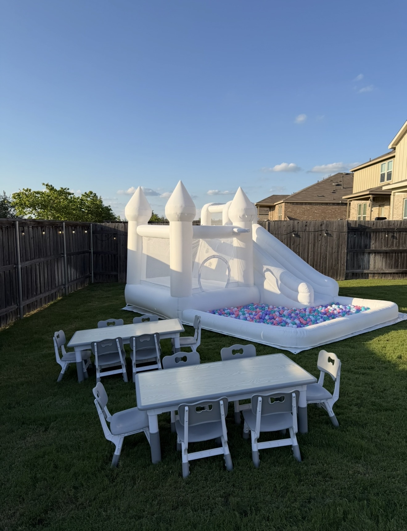 White castle bounce house with children's tables and chairs