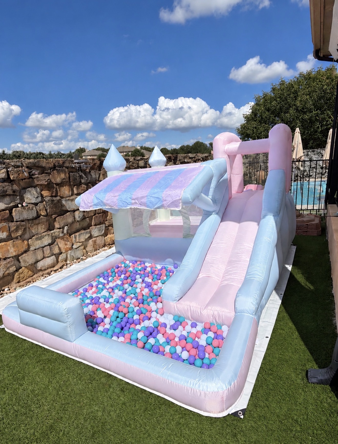 Pink and blue bounce house with ball pit